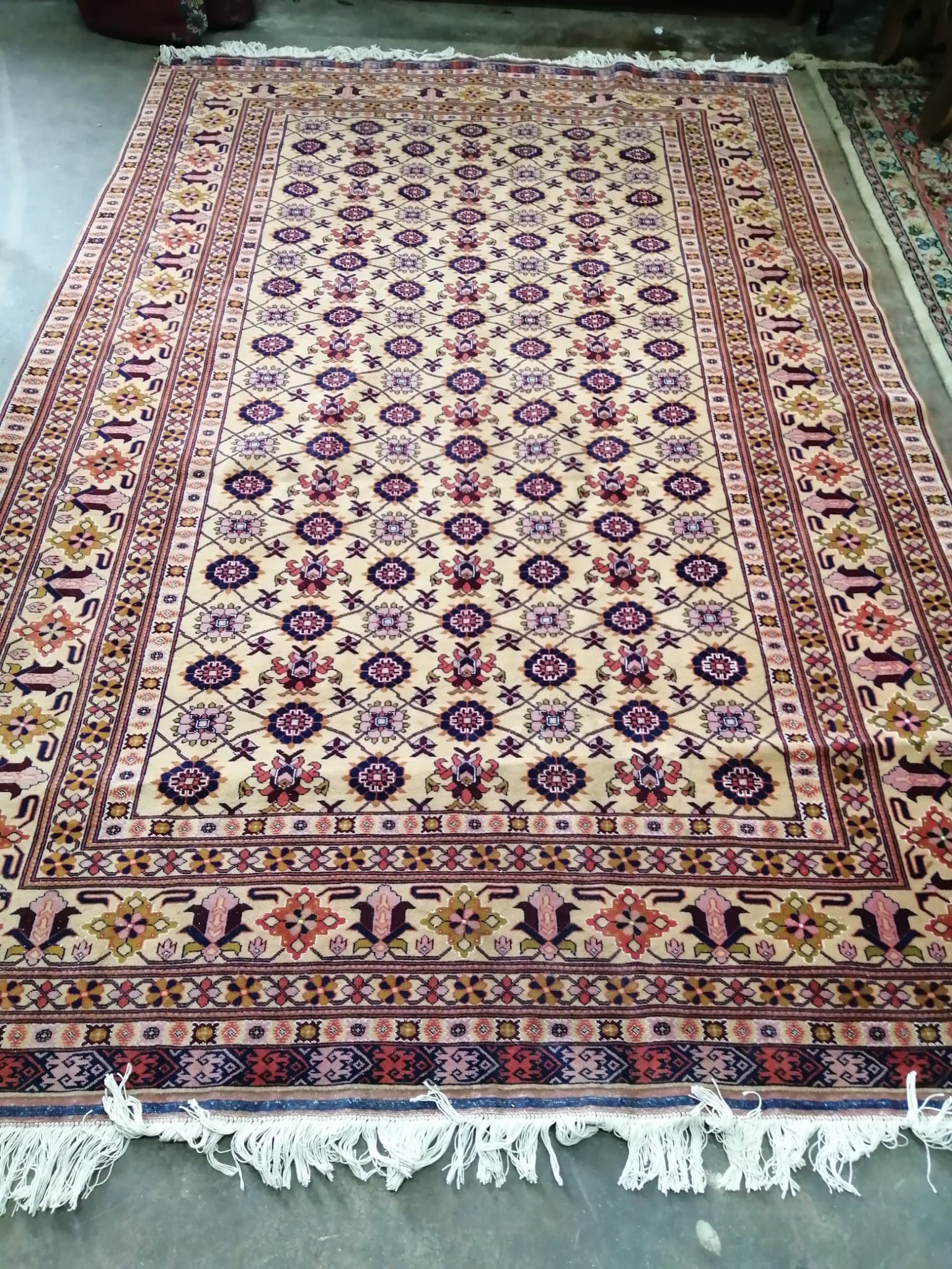 A Hamadan carpet with central field of foliate motifs on a sand coloured ground, 300 x 195cm